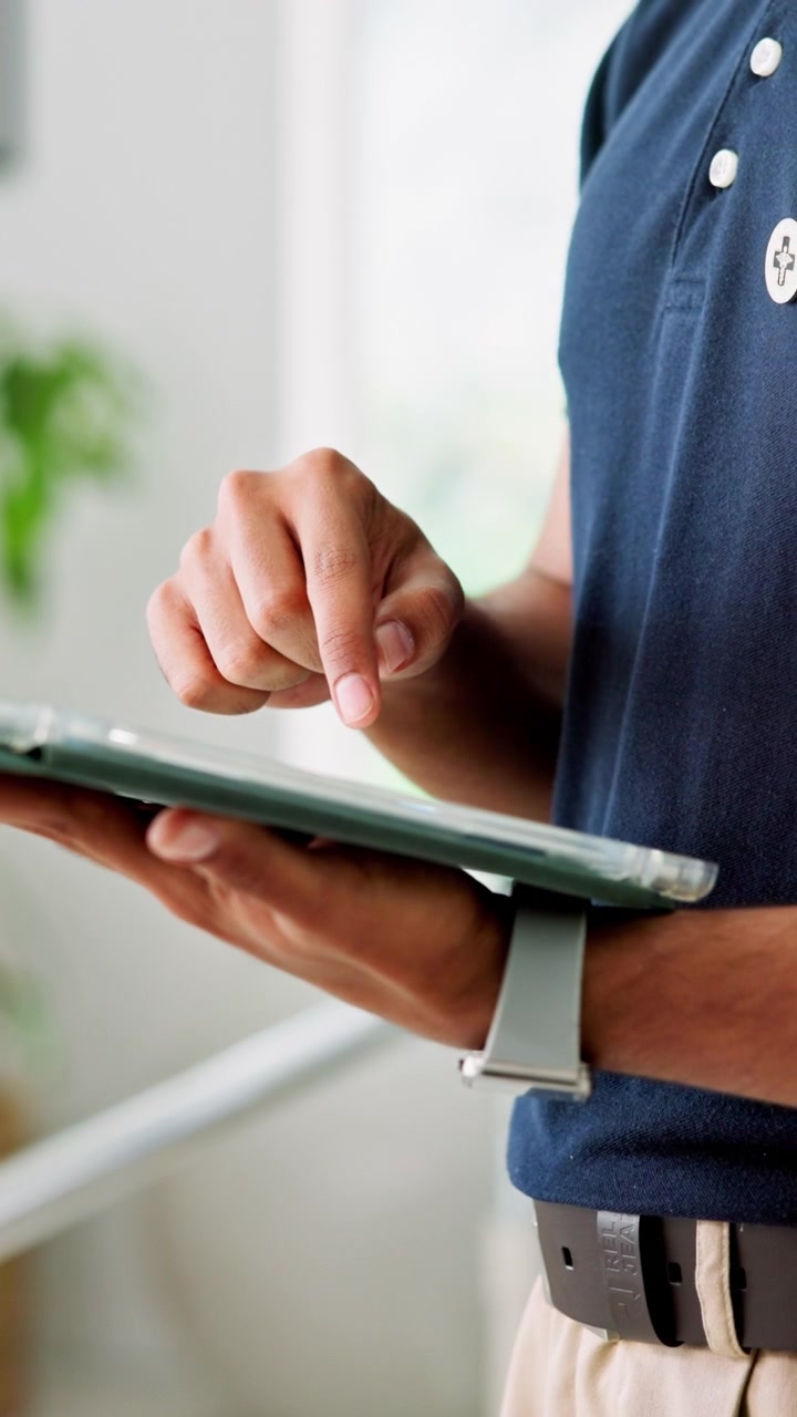 Person Using a Digital Tablet in a Bright Indoor Setting