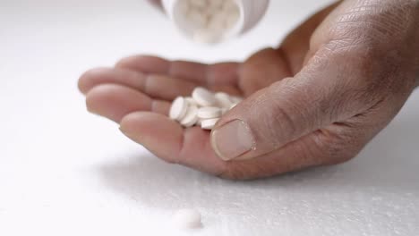 pills from a bottle being poured in hand with white background stock video stock footage