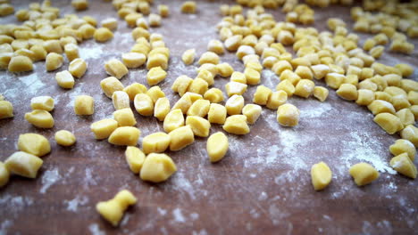 Close-up-panning-of-floured-struffoli-on-wooden-board