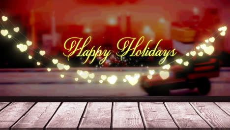 Happy-holidays-text-and-glowing-yellow-heart-shaped-fairy-light-decoration-over-wooden-plank