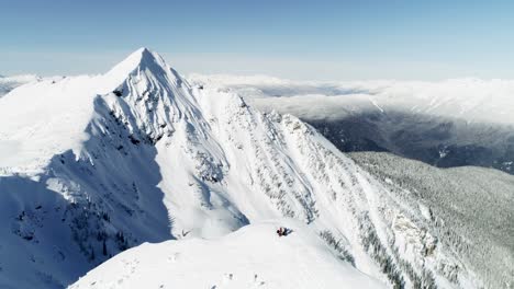 Skiers-standing-on-a-snow-capped-mountain-4k