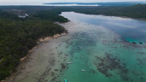 many-fishing-boats-moored-at-a-low-tide-sea-in-Alano-Beach,-Karimunjawa---Central-Java,-Indonesia