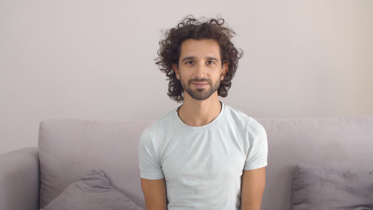 Happy handsome curly haired young man
