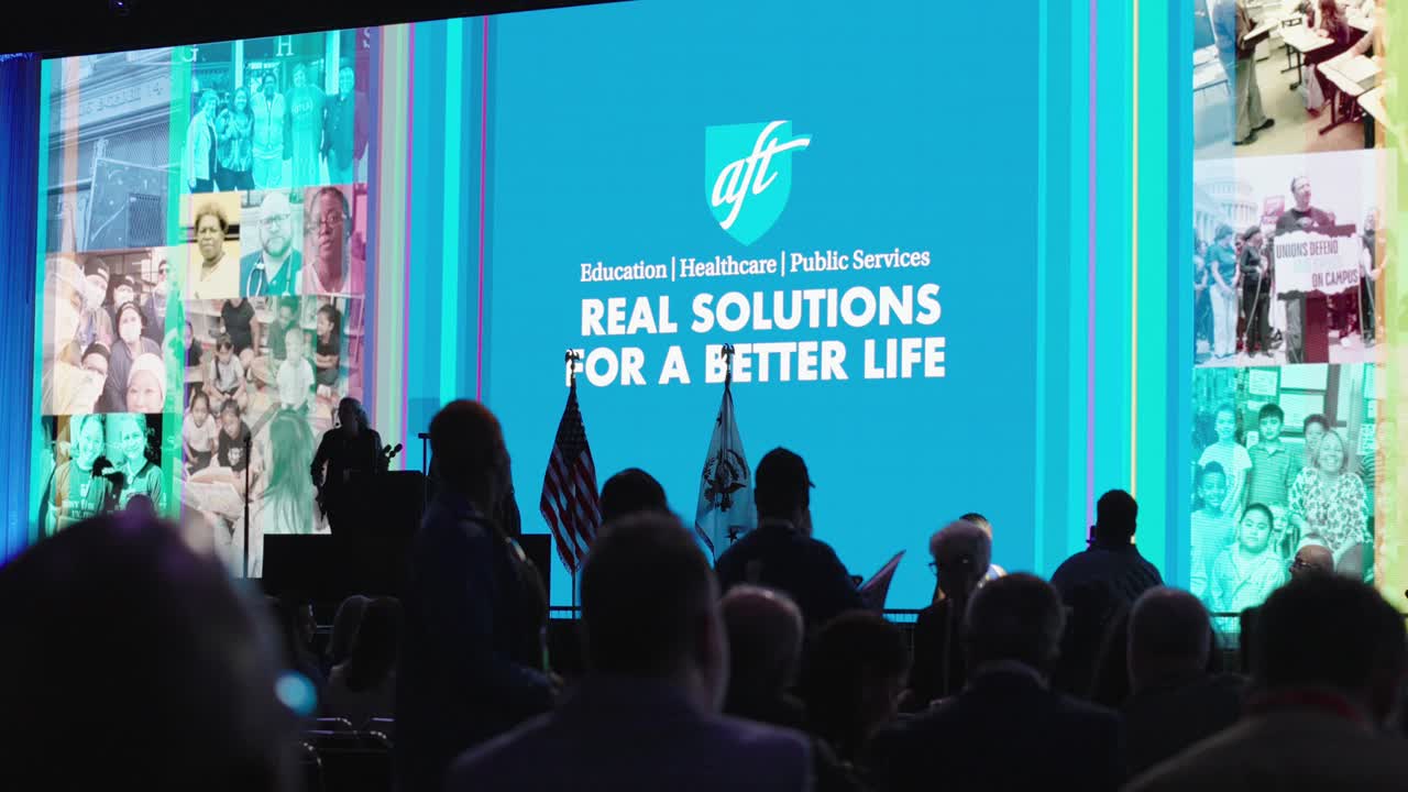 Establishing shot of people participating in Teachers Union at conference hall