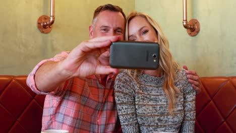 couple taking selfie on mobile phone in restaurant 4k