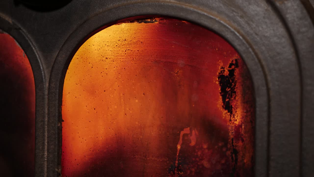 llamas a través de vidrio de estufa de hierro fundido arenoso