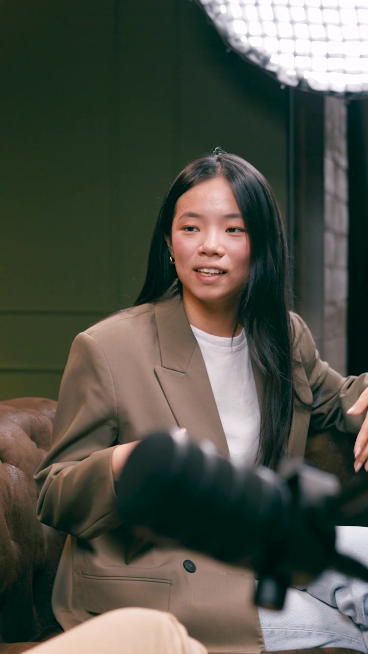 Young Woman Speaking into Microphone During Podcast Interview