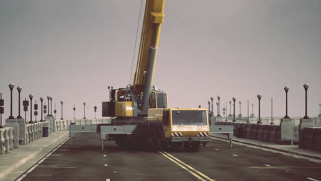 crane operation on a busy pier during overcast weather conditions