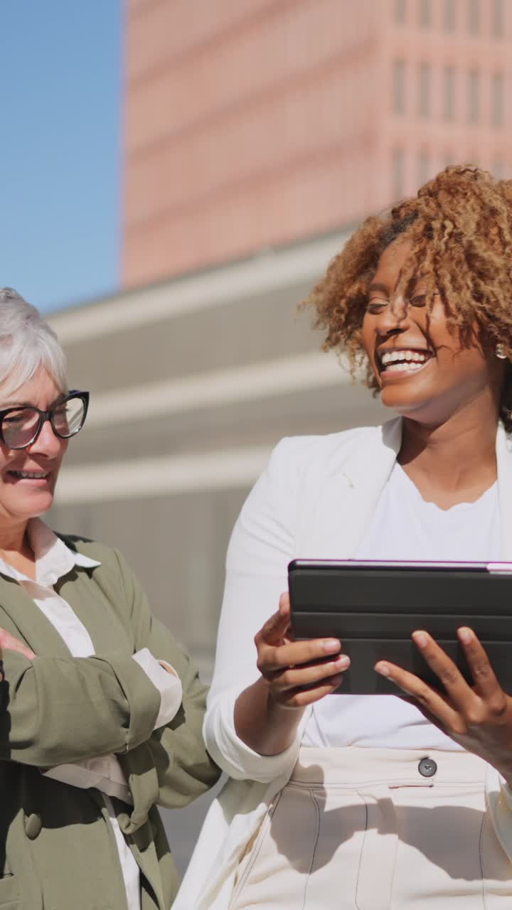 African businesswoman using tablet in an outdoor meeting