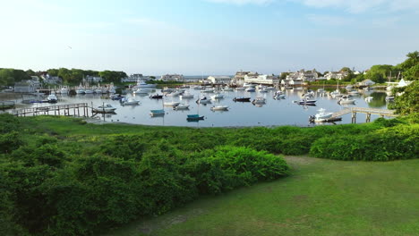 wychmere harbor in harwich, cape cod with boats and lush green garden, aerial view