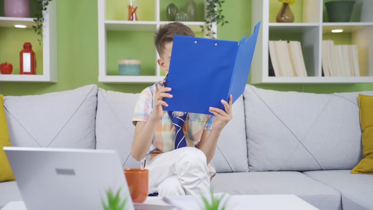 The boy wearing his father's tie has a file in his hand. He is imitating his father.