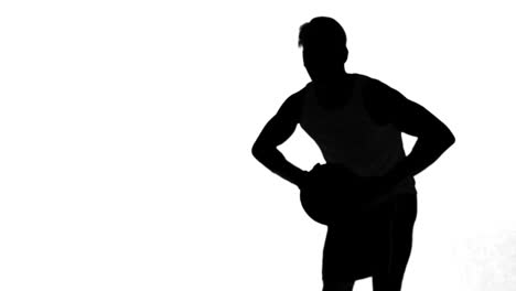 silhouette of a man throwing a basketball on white background