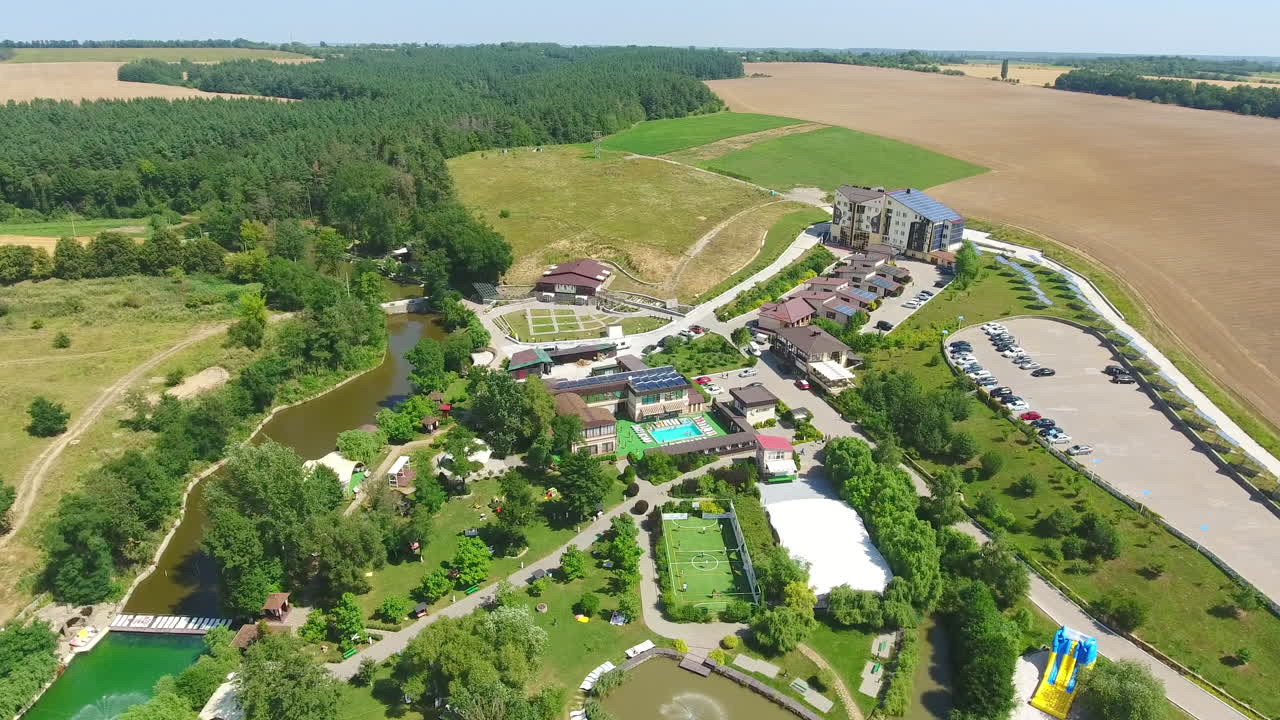 Recreational spa resort situated in the rural territory. Beautiful area for relax and fun at the backdrop of farmlands. Aerial view.