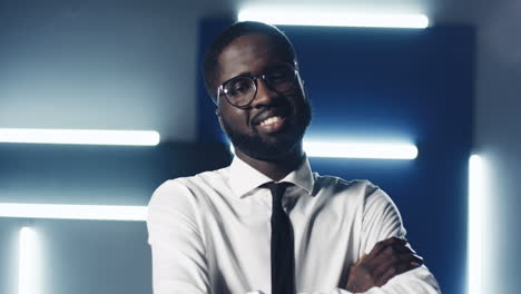 Portrait-Of-The-Smiled-And-Happy-Man-In-Glasses-In-The-Futuristic-Space-Of-The-Office-With-Neon-Lamps