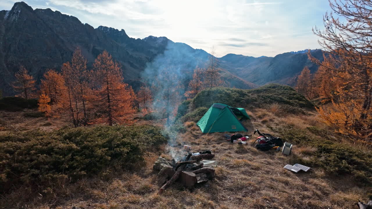Scenic campsite in autumn mountains, vibrant trees, peaceful outdoor escape