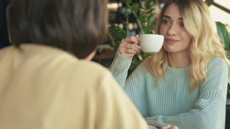 young female friends talking in a coffee shop 1