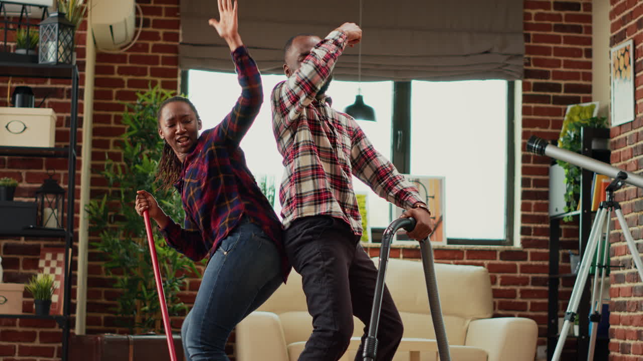 Active people dancing and doing housework together