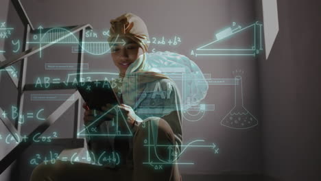 animación de procesamiento de datos científicos sobre una mujer biracial en hijab usando una computadora portátil