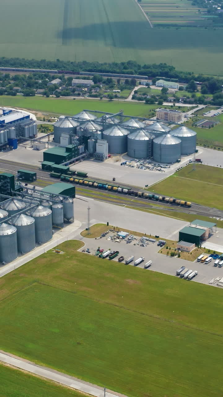 Luftaufnahme von großen Fabrik-Metalllagern. Moderne industrielle Getreidesilos. Vertikales Video