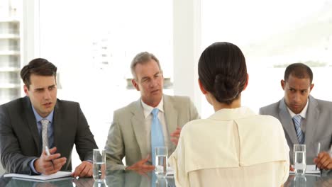 businesswoman being interviewed by tough panel