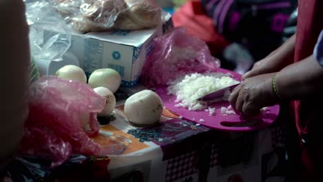 Person-chopping-onion-on-the-table