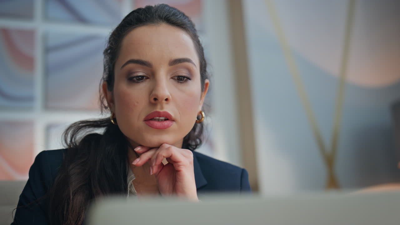 Serious executive working office laptop looking solution at workplace portrait