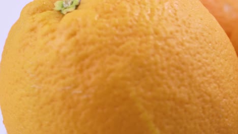 Close-Up-Frische-Valencia-Orange-In-Scheiben-Geschnitten-Mit-Weißem-Hintergrund-Flachen-Fokus-Und-Langsam-Drehen