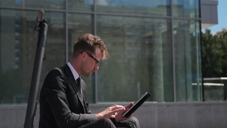 businessman working on a tablet outside the office