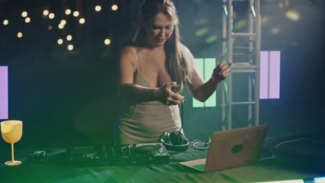 a woman djing at a vibrant night event