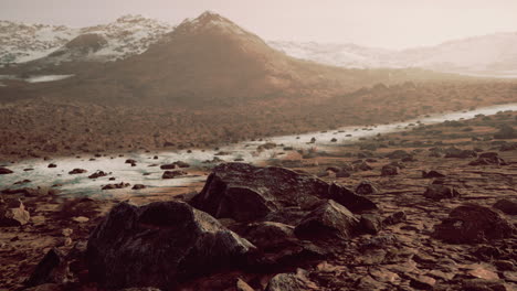 Sunrise-in-a-rocky-desert-with-shadows-cast-by-the-hills