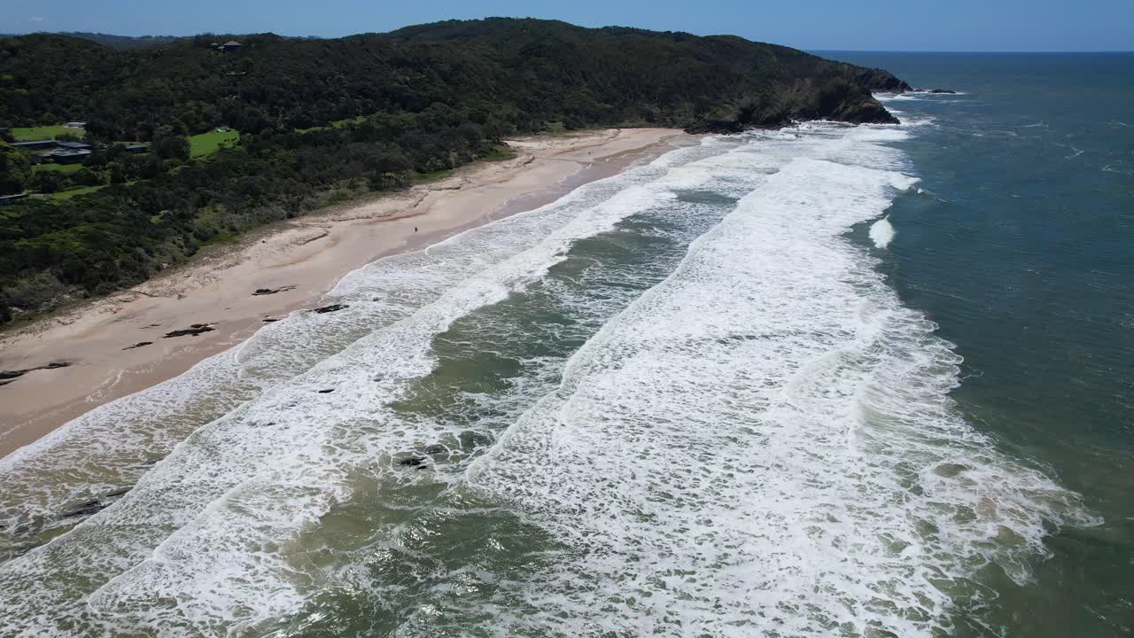 Aerial View of a Secluded Beach with Waves Crashing on the Shore