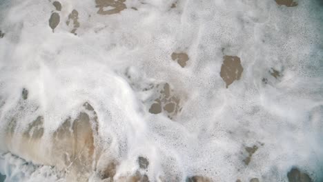 Foamy-waves-crashing-on-the-shore---Close-up,-Slow-motion-shot