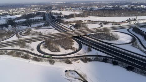 snowy autobahn or interstate intersection, aerial drone winter view on sunny day