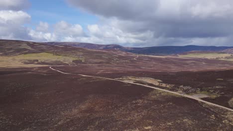 Aerial-flying-backwards-revealing-Cairngorms-immensity,-Scotland