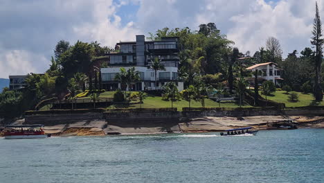 modern waterfront mansion and boats on a scenic lake