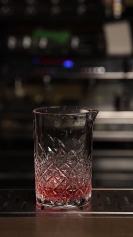 bartender preparing a pink cocktail