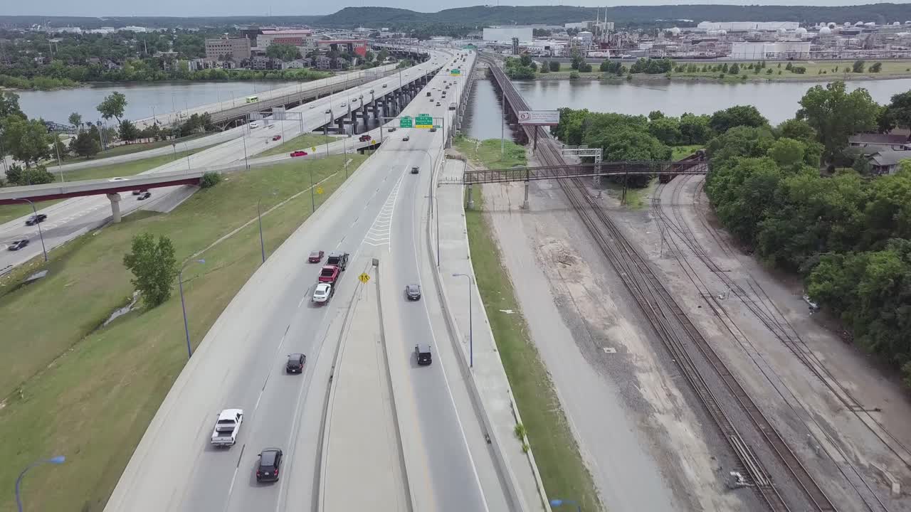 Travel on a highway across a river flying overhead
