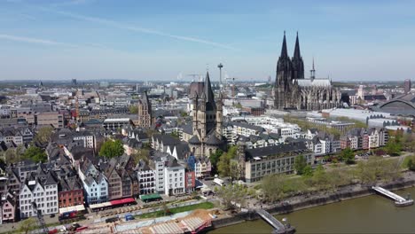 cologne city landmarks and colorful waterfront houses on sunny day, aerial