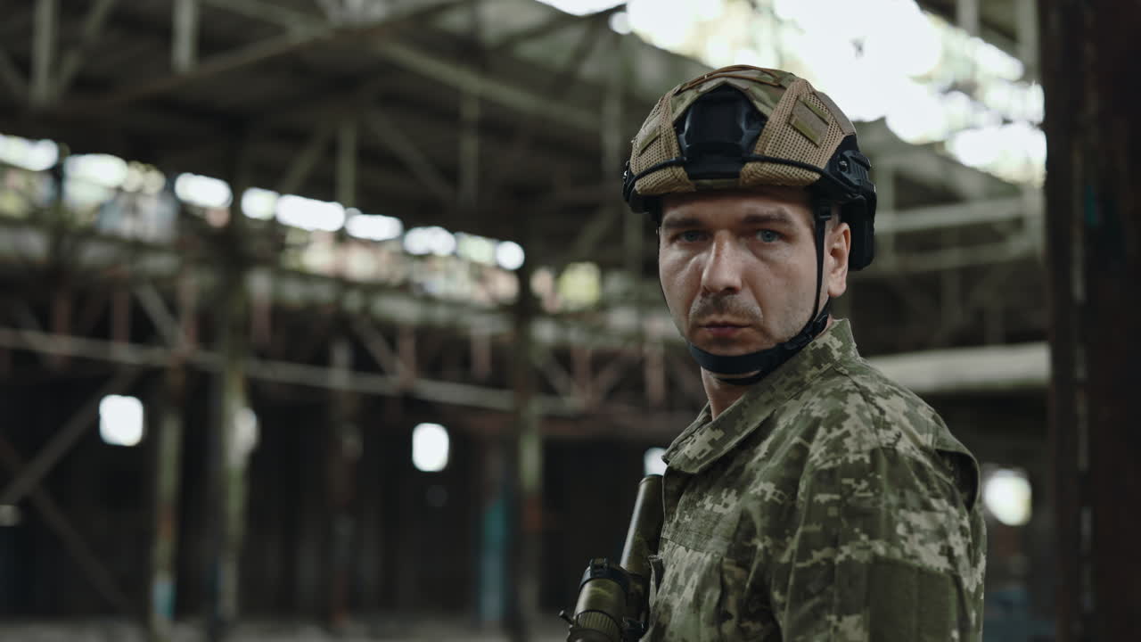 Soldier in Camouflage Uniform at Abandoned Factory