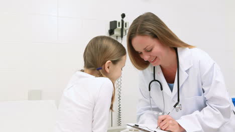 female doctor writing on a clipboard