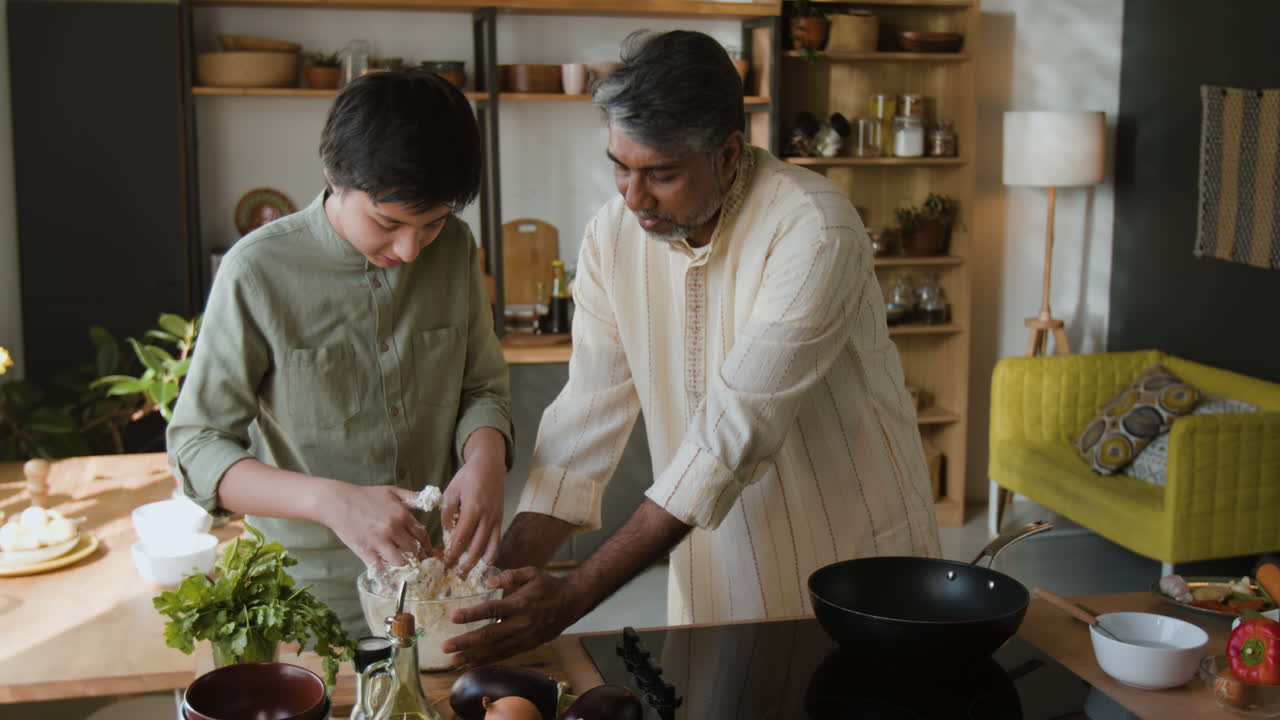 Father and Son Cooking Together in the Kitchen