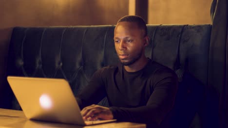 professional male working remotely on a laptop from a caf?