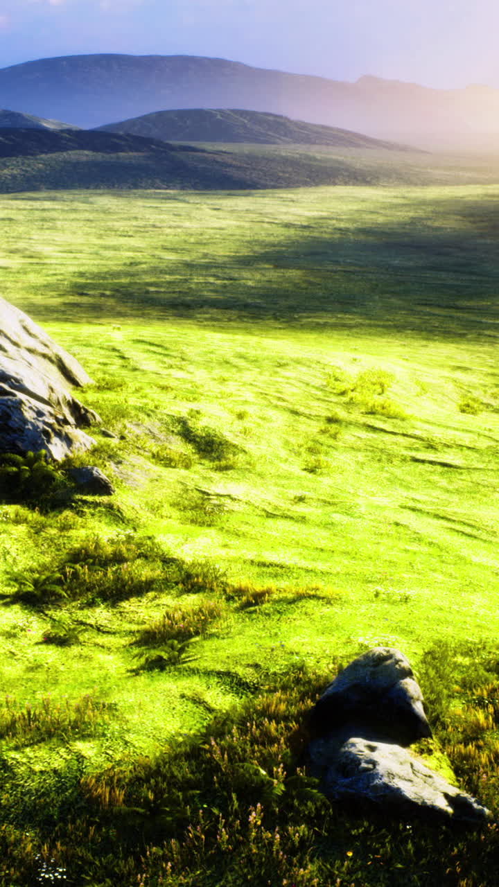 Vibrant green landscape with rocky outcrops in the golden hour sunlight