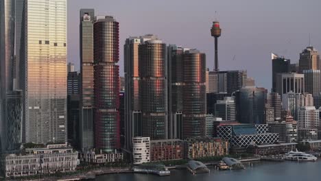 skyline buildings at darling harbour in sydney, australia - drone cityscape in the evening