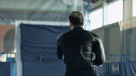 man practicing kendo in an indoor arena