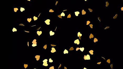 falling gold hearts on a black background
