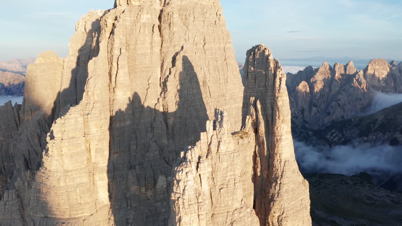 Aerial fly past Tre Cime Di Lavaredo Towers during sunrise, Dolomites, Italy