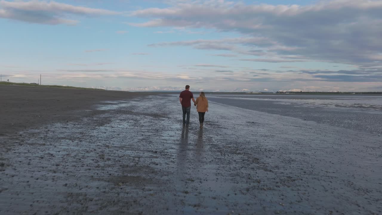 Couple walking on beach in Kenai, Alaska