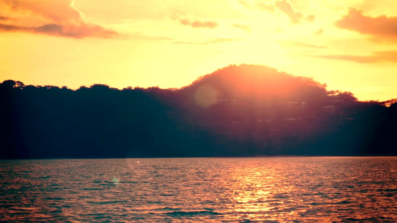 Establishing shot of an island at sunset.