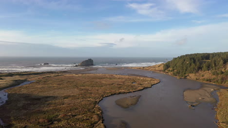 aerial pan right and flying forward shot of sixes river, cape blanco state park